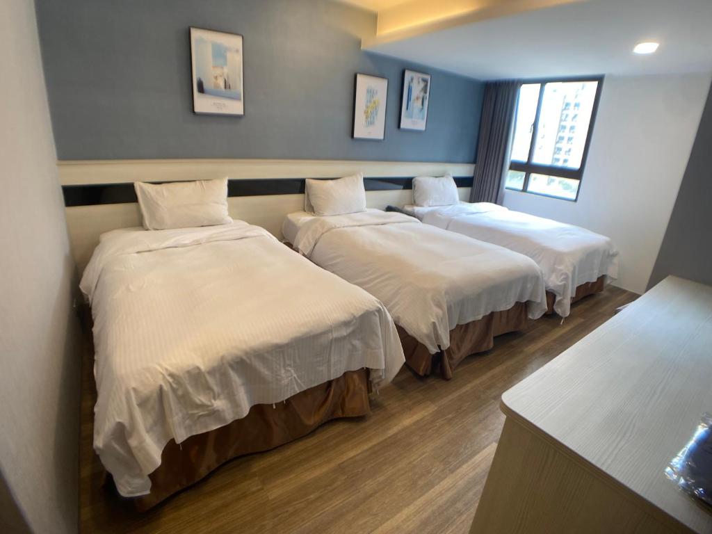 Postel nebo postele na pokoji v ubytování Bonjour Hotel