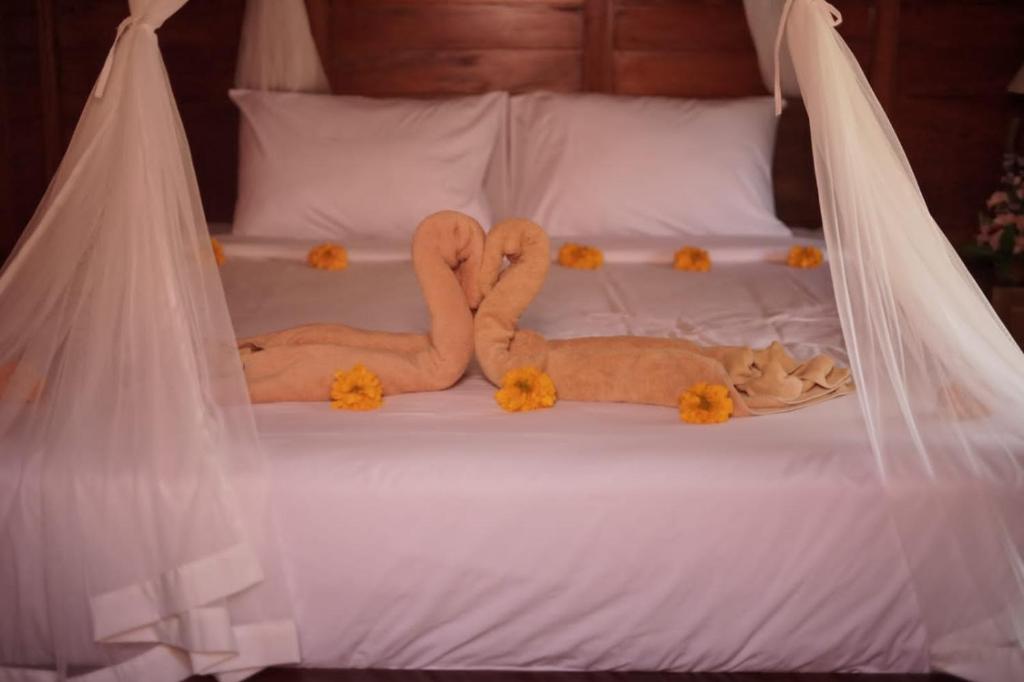 Letto o letti in una camera di Teba Junjungan Cottages