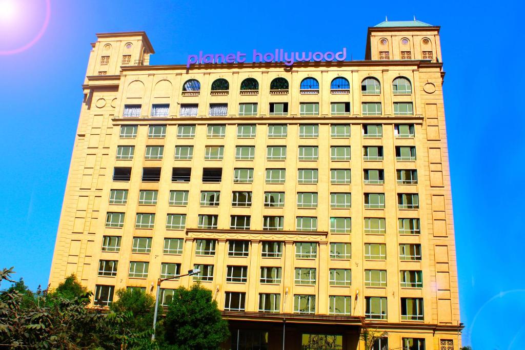 a building with a sign on the top of it at Planet Hollywood Thane in Thane