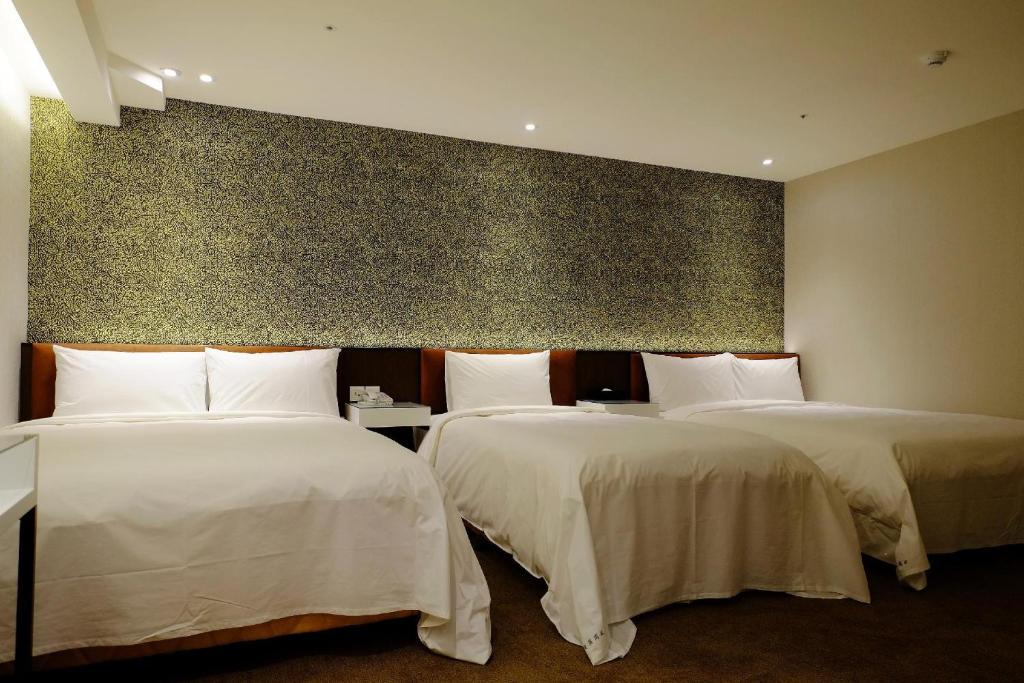 Ένα ή περισσότερα κρεβάτια σε δωμάτιο στο Hotel Puri Taipei Station Branch
