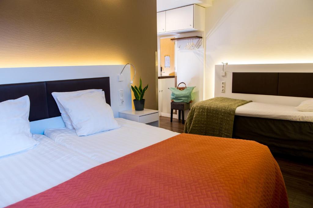 Letto o letti in una camera di Hotel Emma