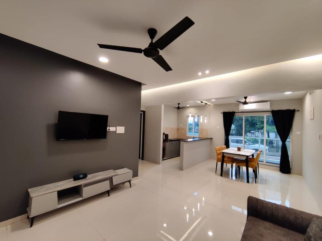 a living room with a ceiling fan and a table at Wandr Zen in Khopoli