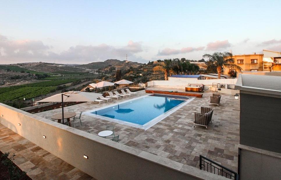 a swimming pool on top of a building at מטע וכרם in Elqosh