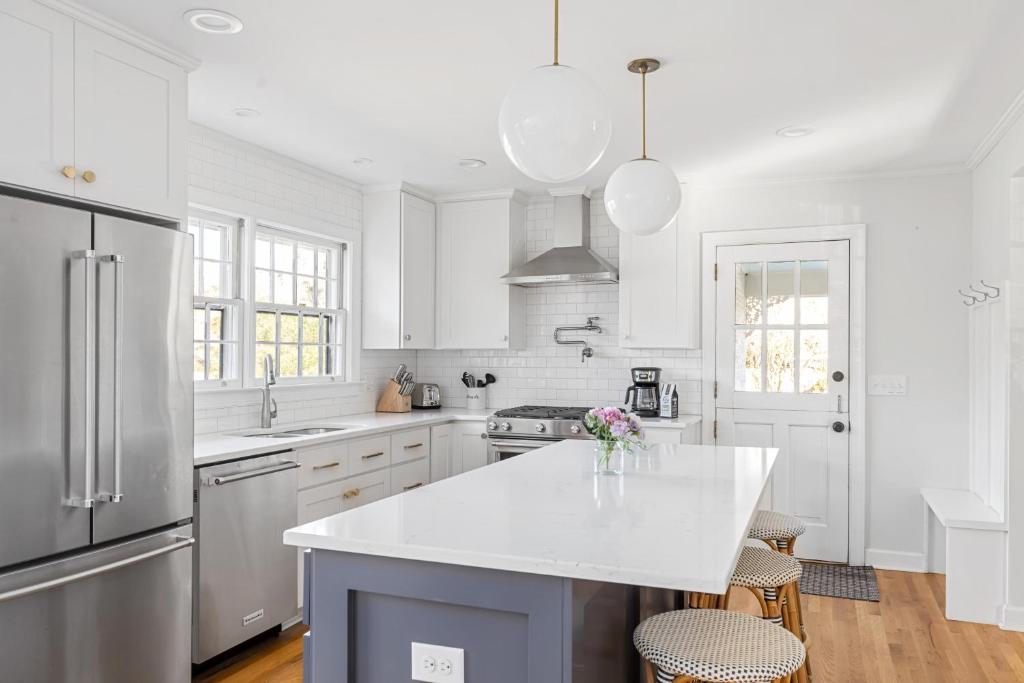 a kitchen with white cabinets and a white counter top at * Affordable Luxury Park Circle, Tres Chic! * in Charleston