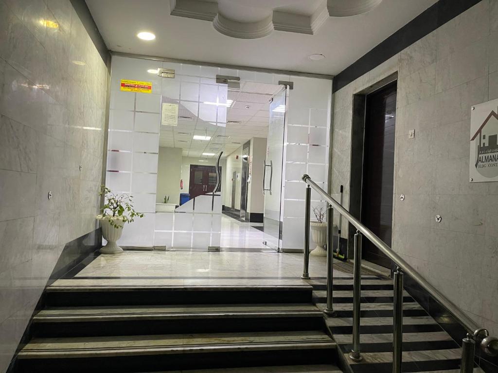 a hallway with stairs in a building with a mirror at Discover Khorfkan in Khor Fakkan