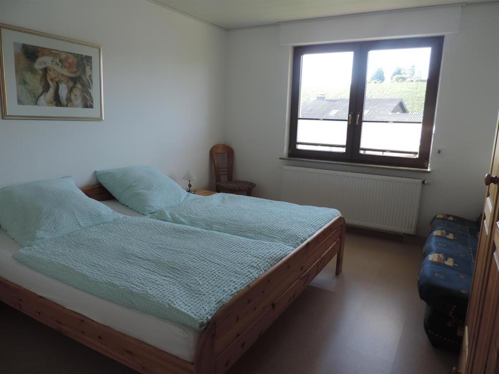 a bedroom with a bed and a window at Ferienwohnung Am Saarbogen 