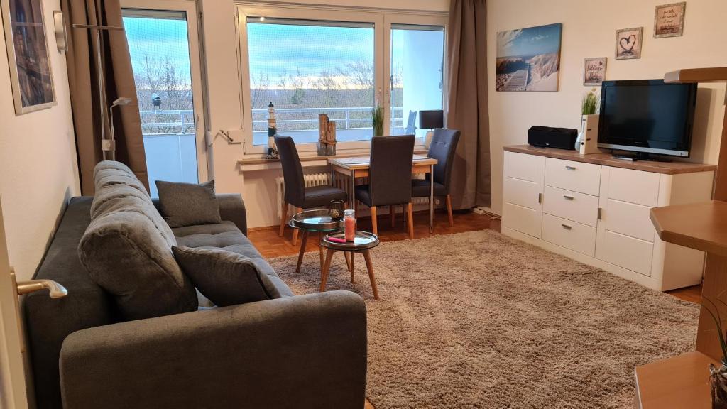 a living room with a couch and a table at PEMATRA Ferienwohnung Seeschwalbe in Travemünde