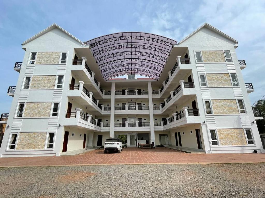 a large building with a car parked in front of it at O Mary River Resort in Sihanoukville