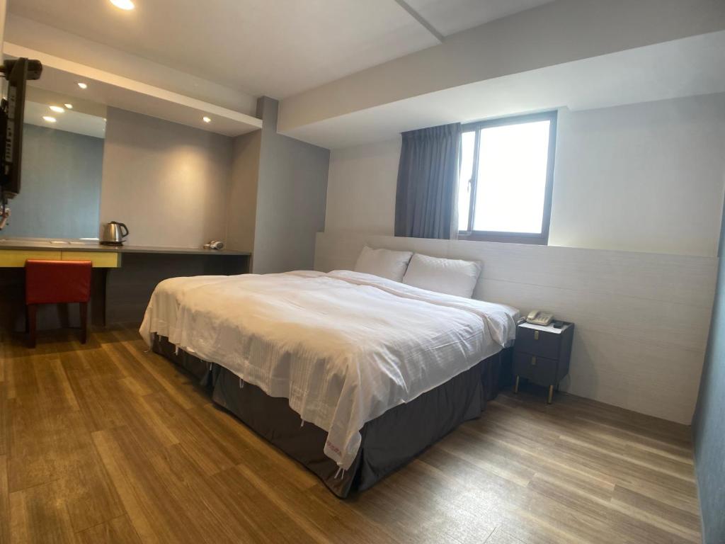 Postel nebo postele na pokoji v ubytování Bonjour Hotel