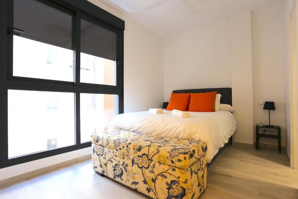 A bed or beds in a room at SOUL Malaga City Apartment