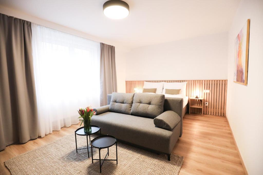 a living room with a couch and a bed at Dubno Eat & Sleep in Nová Dubnica