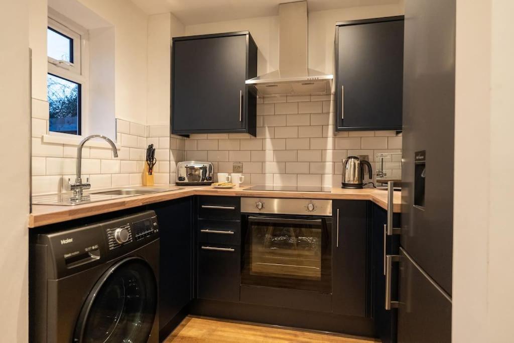 a kitchen with a black dishwasher and a sink at The Mews, Amazing Newport 2 BR, Excellent location, Parking, Perfect for Contractors in Newport