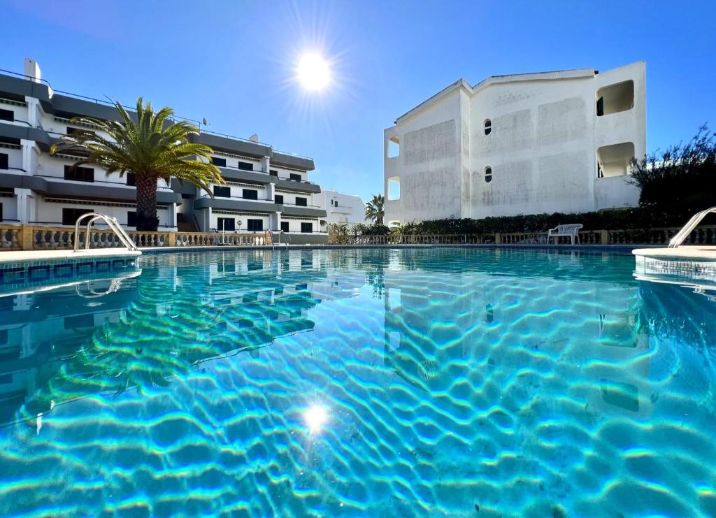 a large swimming pool in front of a building at Albufeira Delight with Pool by Homing in Guia