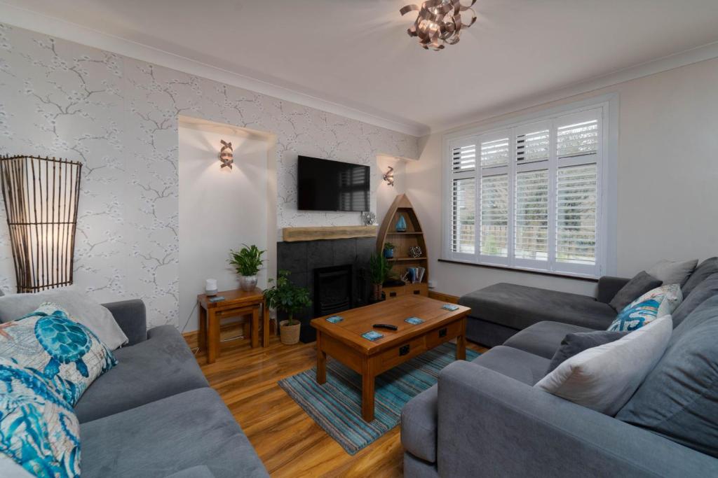 a living room with a couch and a fireplace at Trevelyan in St Ives