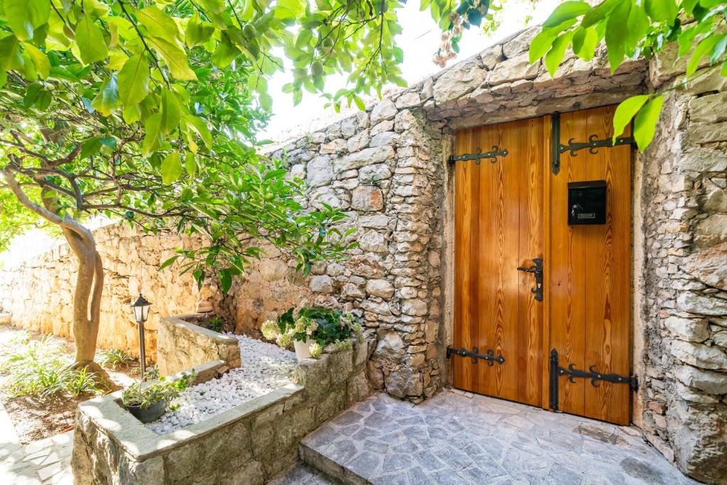a stone house with a wooden door at Villa Vista Old Town in Cavtat