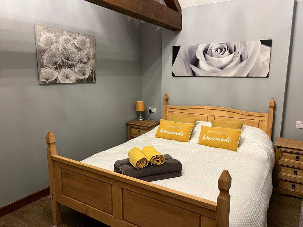 a bedroom with a bed with two yellow pillows at Rife Lodges in Arundel