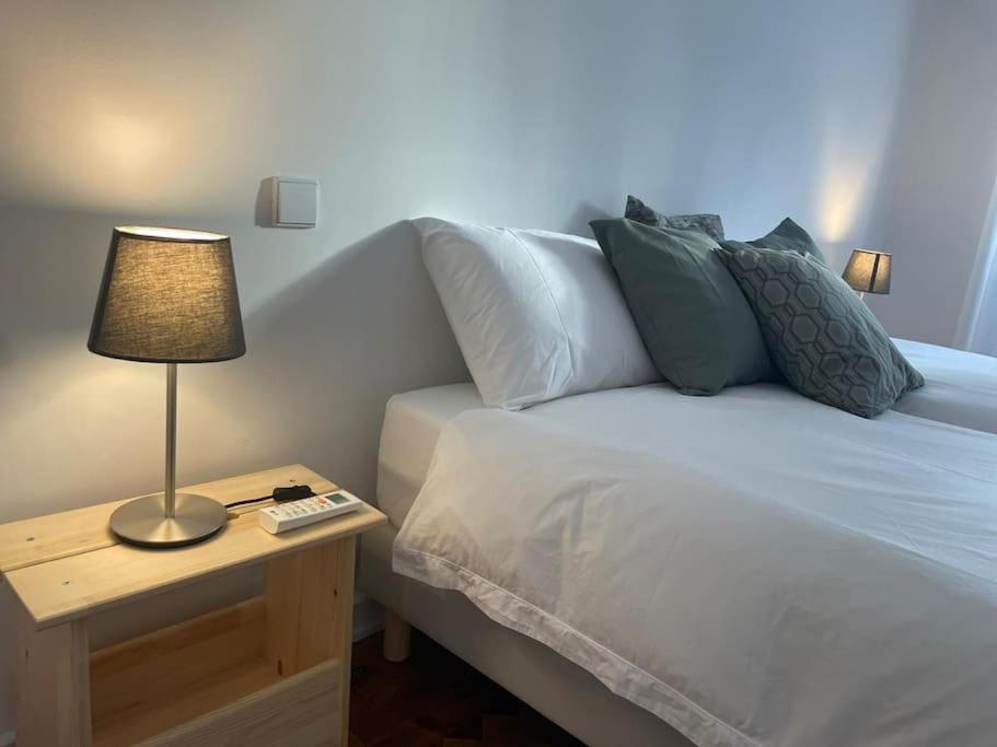 a bedroom with a bed with a lamp on a table at ASF Home in Lisbon