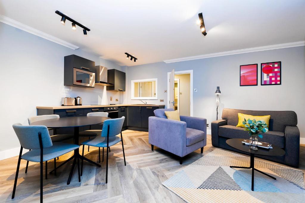 a living room and kitchen with a table and chairs at Staycity Aparthotels, Dublin, Christchurch in Dublin