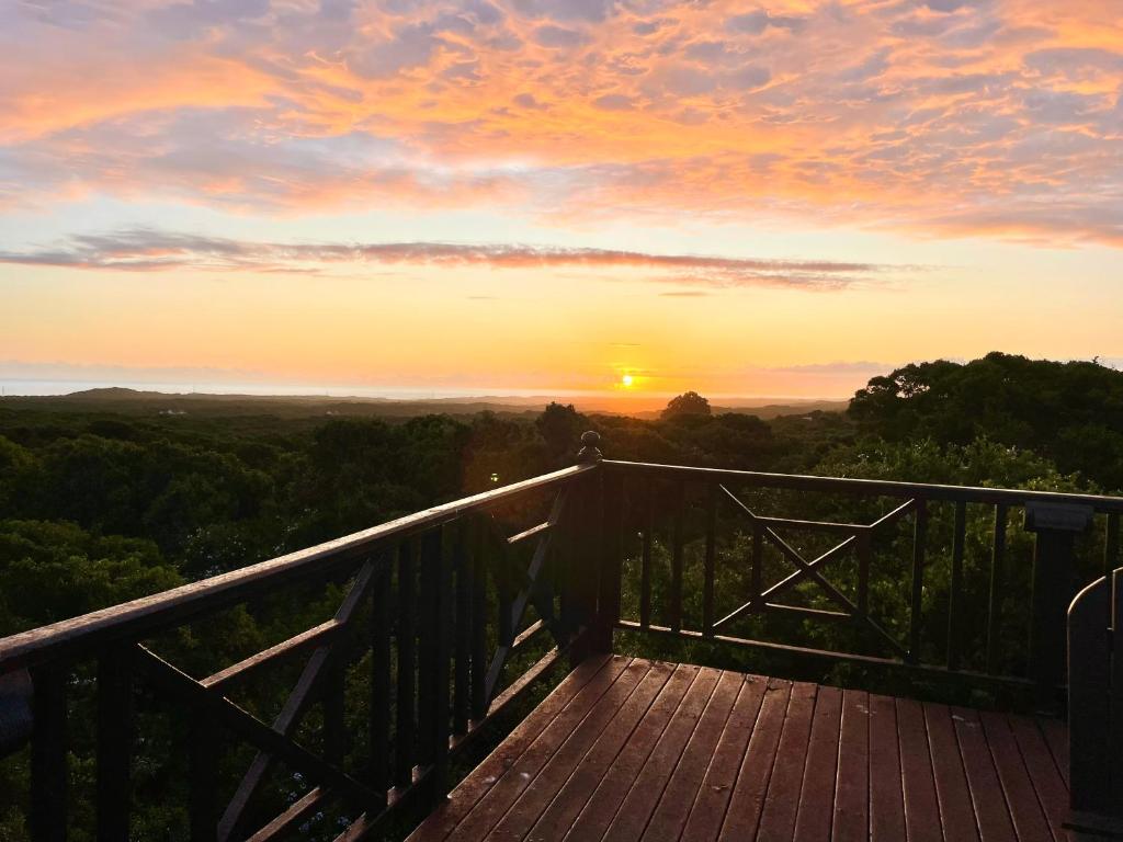 a view of a sunset from a wooden deck at Getaway cottage in Lovemore Park