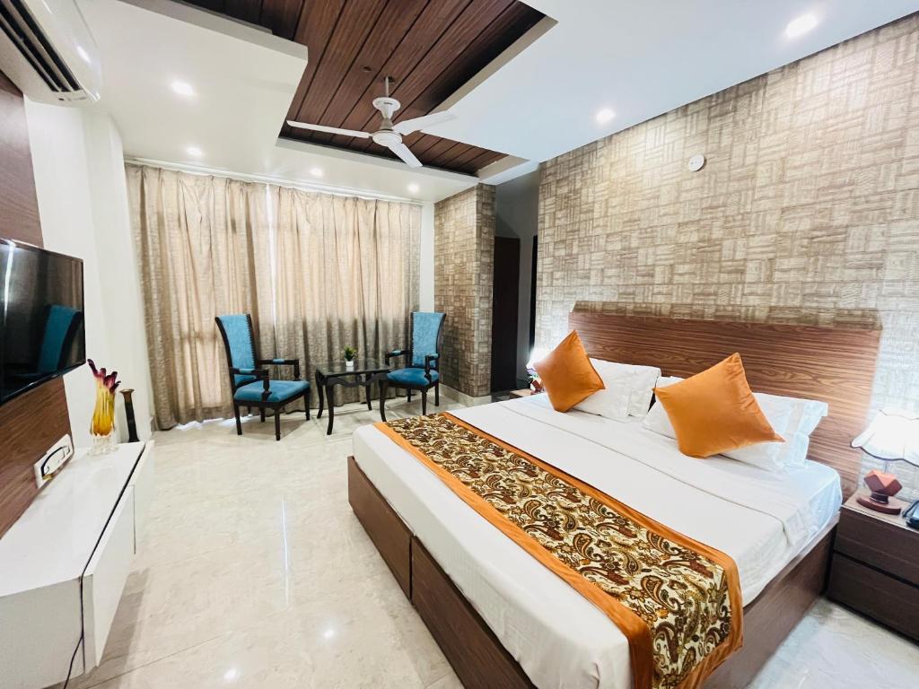 a bedroom with a bed and a table and chairs at Hotel Dayal Regency, Shushant Lok sector 29, Near Fortis Hospital in Gurgaon