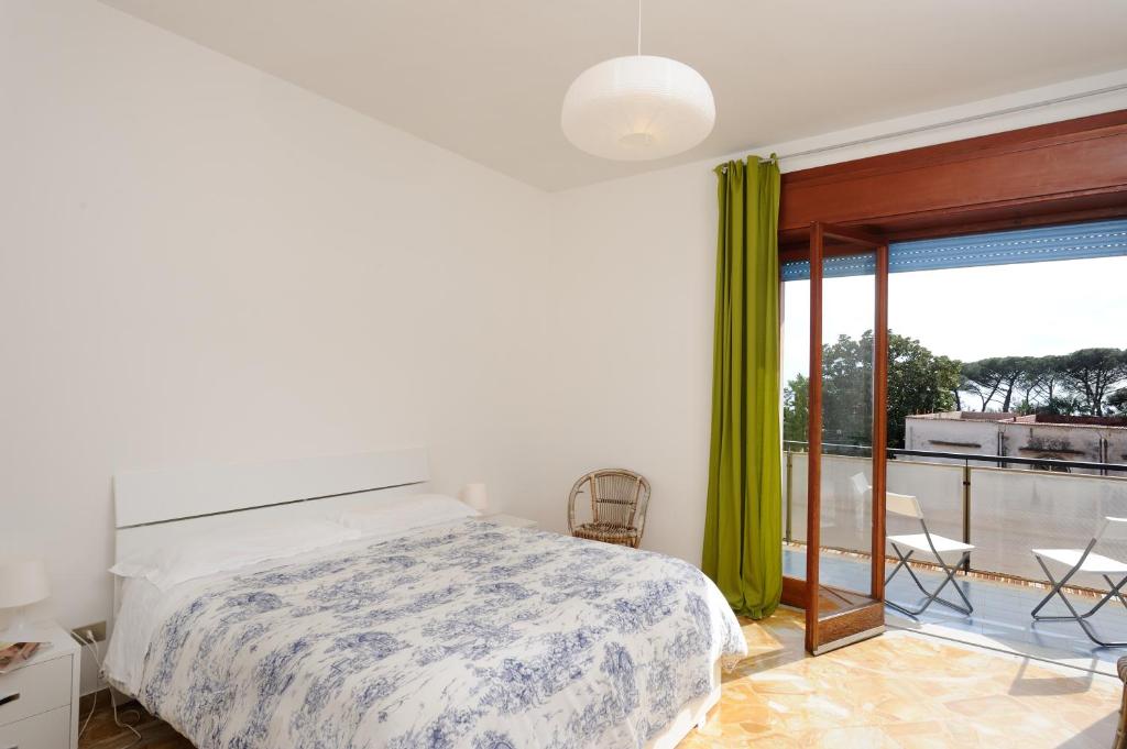 a bedroom with a bed and a balcony at Tizi Apartments in Maiori