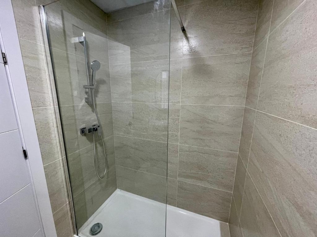 a bathroom with a shower with a glass door at LHOME CÁDIZ in Cádiz