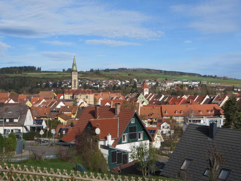 a city with roofs of houses and a clock tower at Ferienwohnung Stadtblick in Bräunlingen
