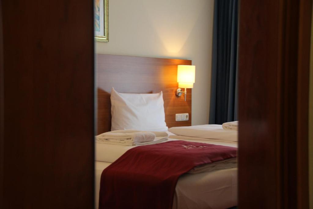 Postel nebo postele na pokoji v ubytování Abasto Hotel Eichenau