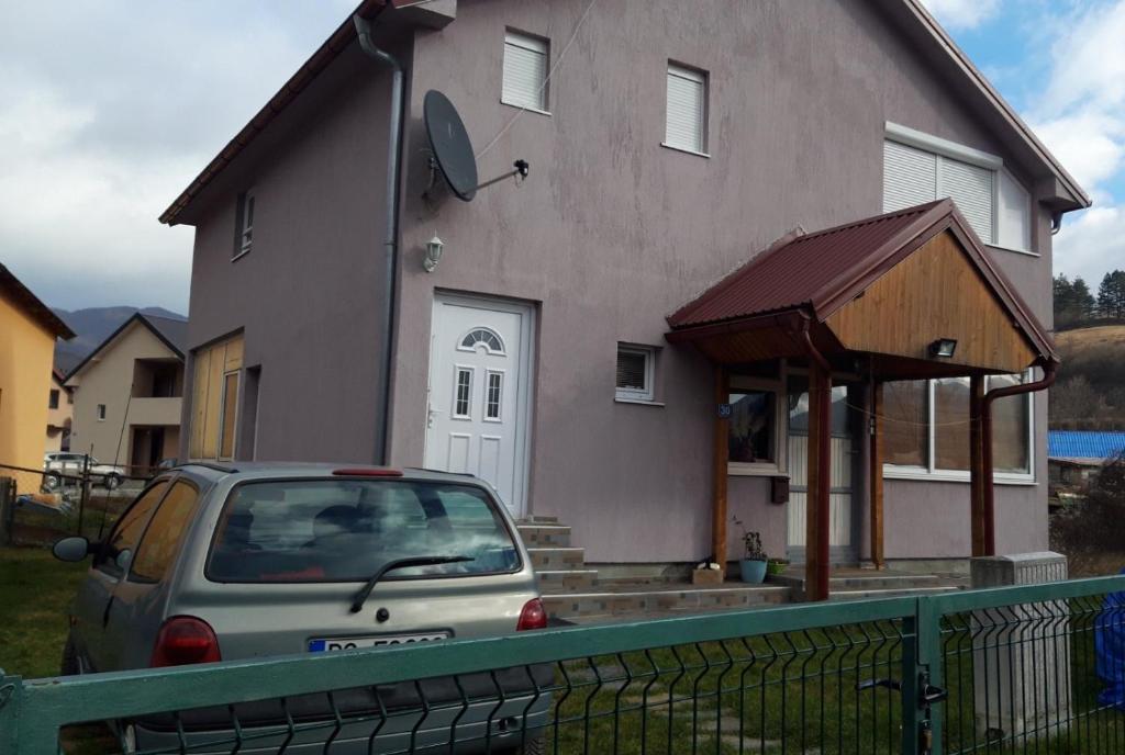 a car parked in front of a house at GUESTHOUSE TARA in Kolašin