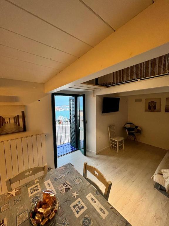 a dining room with a table and a room with a balcony at La dimora sul porto in Termoli