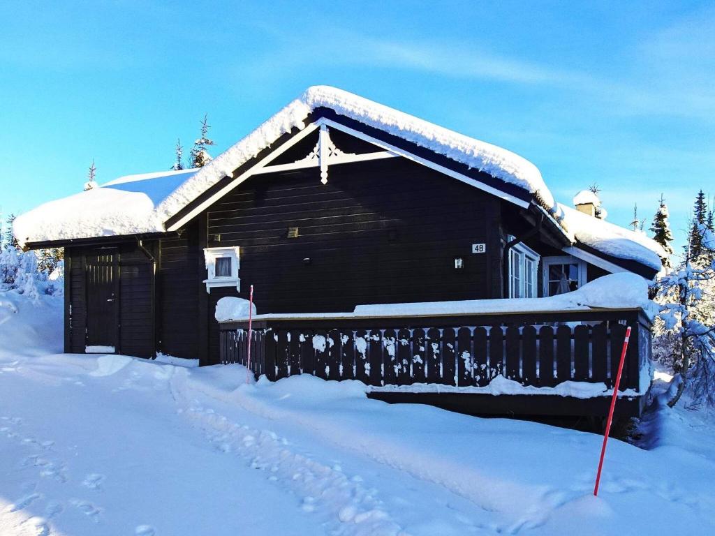 a log cabin with snow on the roof at 10 person holiday home in Svingvoll-By Traum in Svingvoll