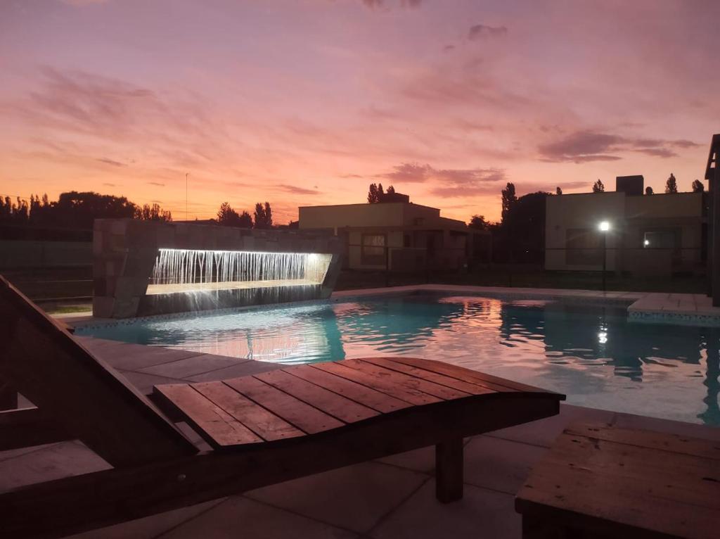 a swimming pool with a waterfall and a fountain at Buenas Tierras Cabañas in San Rafael