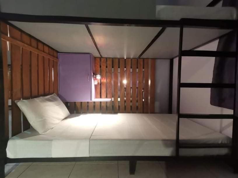 a bedroom with a bunk bed with a window at Lojed Sean bed and space in Manila