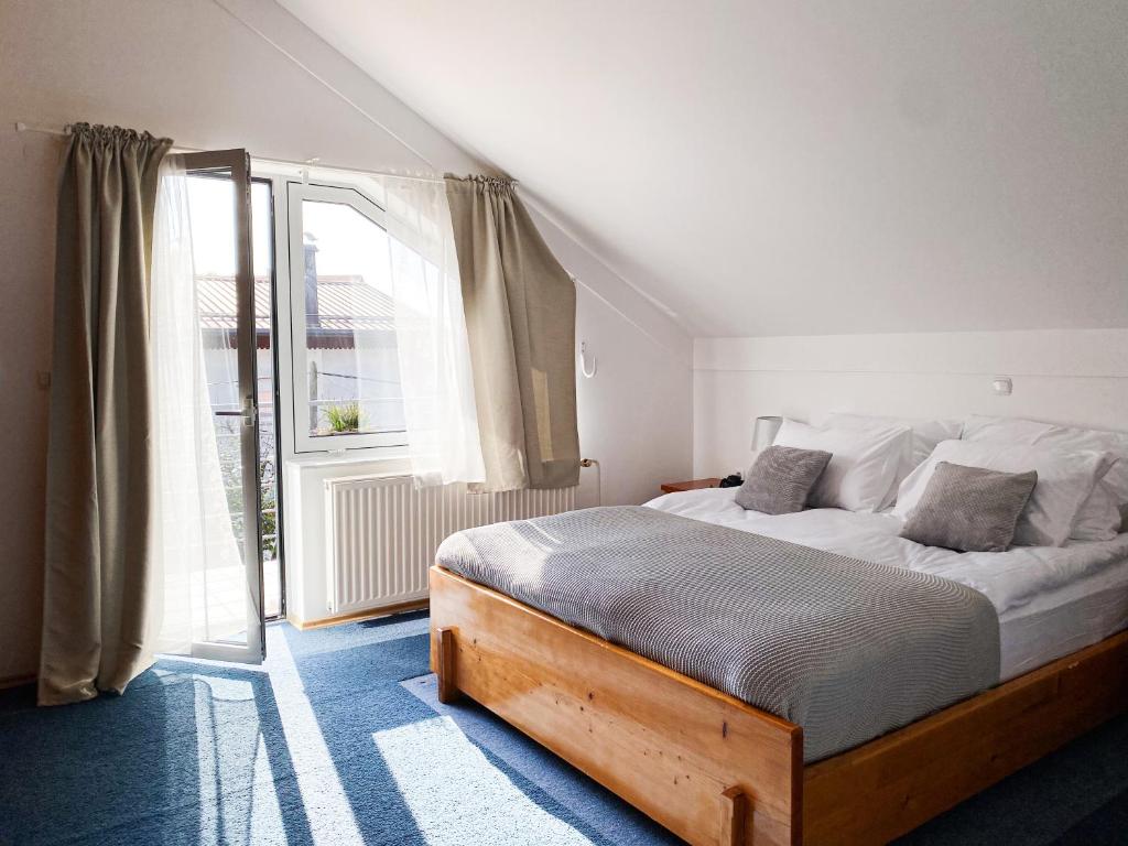 Postel nebo postele na pokoji v ubytování Fado Apartments Lendava