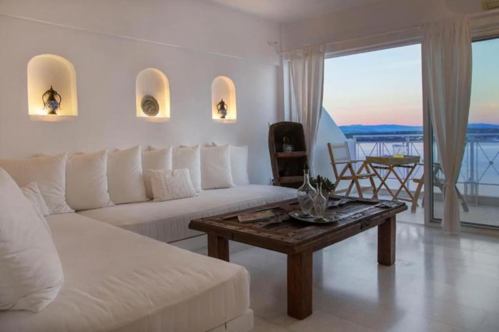 a living room with a white couch and a coffee table at Spetses Sea View Luxury House in Spetses
