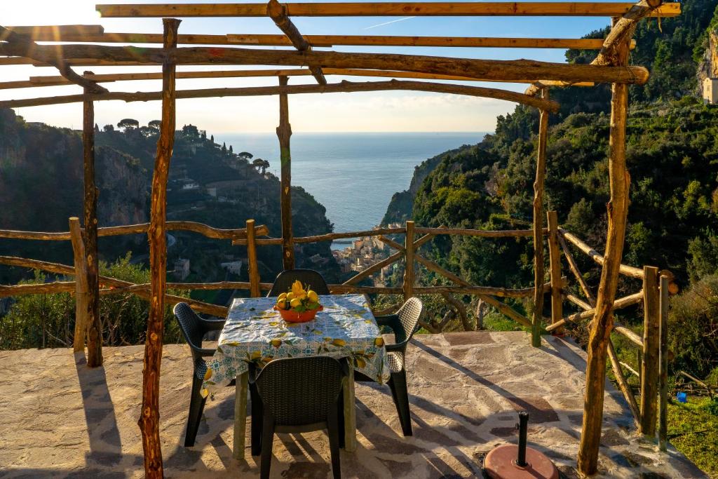 a table and chairs on a balcony with a view of the ocean at Sole Holiday House in Pontone