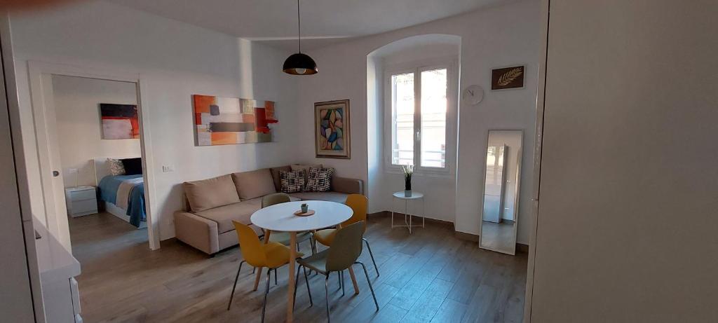 a living room with a table and chairs and a couch at Alba Roma Holiday Home in Rome