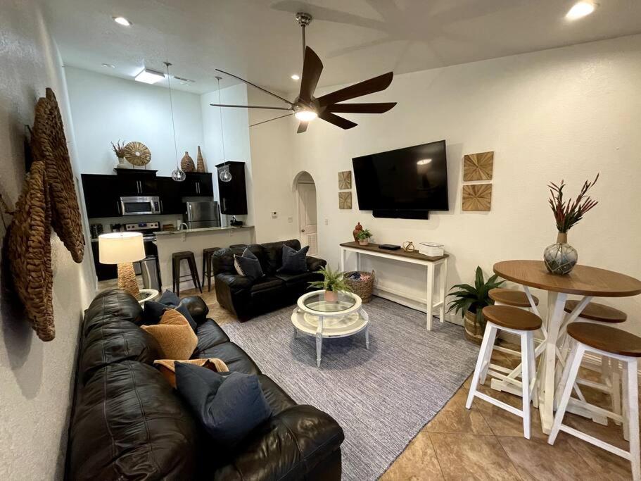 a living room with a black leather couch and a table at Tanglewood Condo in Hot Springs