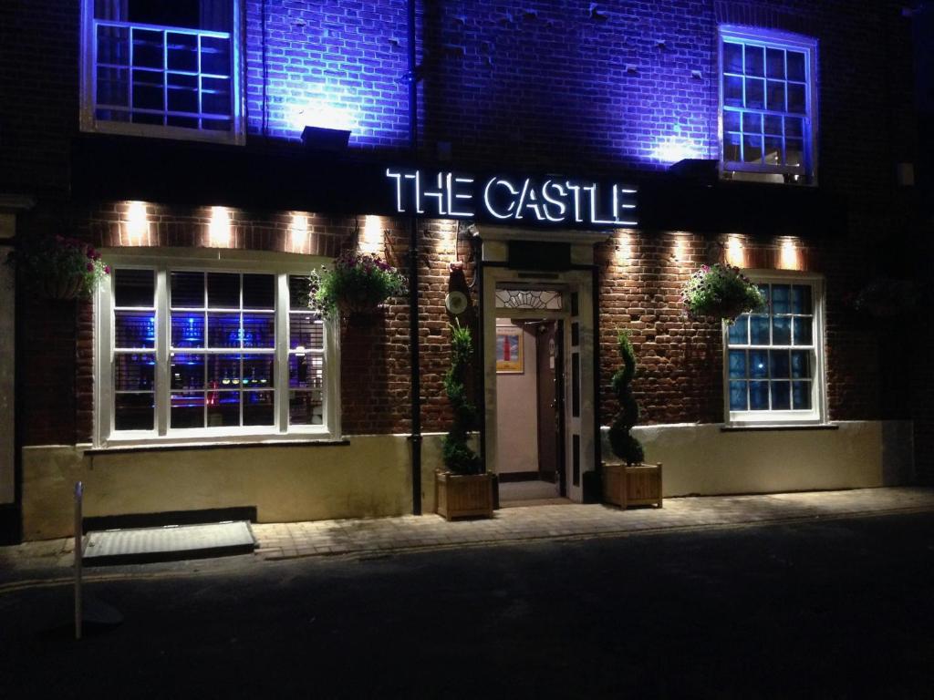 a brick building with a sign that reads the castle at The Castle in Norwich