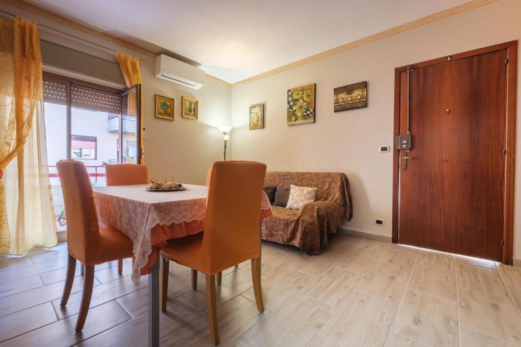 sala de estar con mesa y sofá en Happy Home, en Taormina