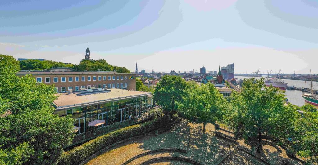 a view of a city with buildings and trees at Jugendherberge Hamburg Auf dem Stintfang-Membership required in Hamburg