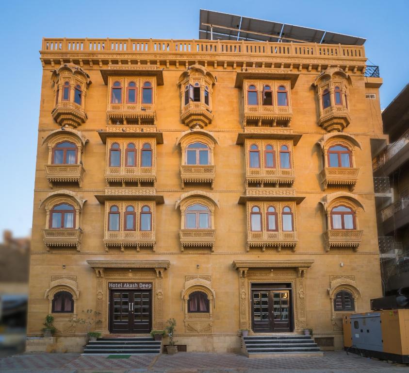 a yellow building with balconies on the side of it at Hotel Akashdeep - Located City Centre in Jaisalmer