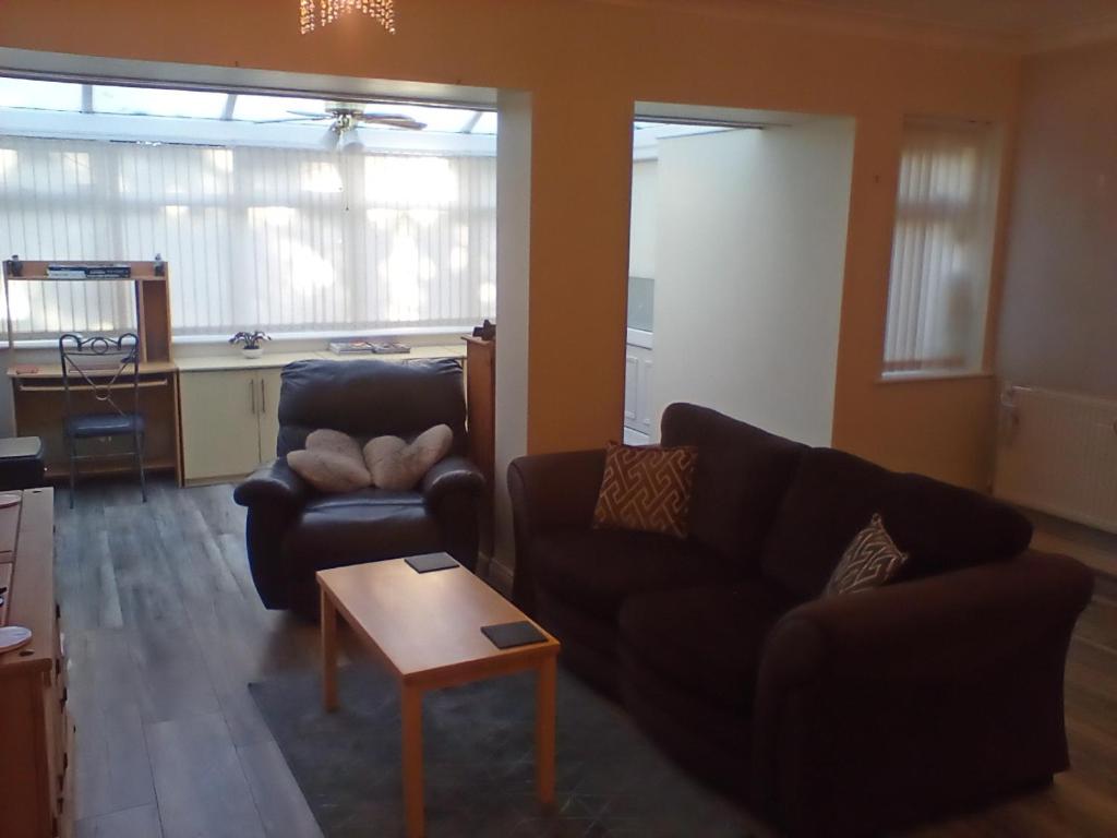 a living room with two couches and a coffee table at The Annex - Guest Gardens in Milton Keynes