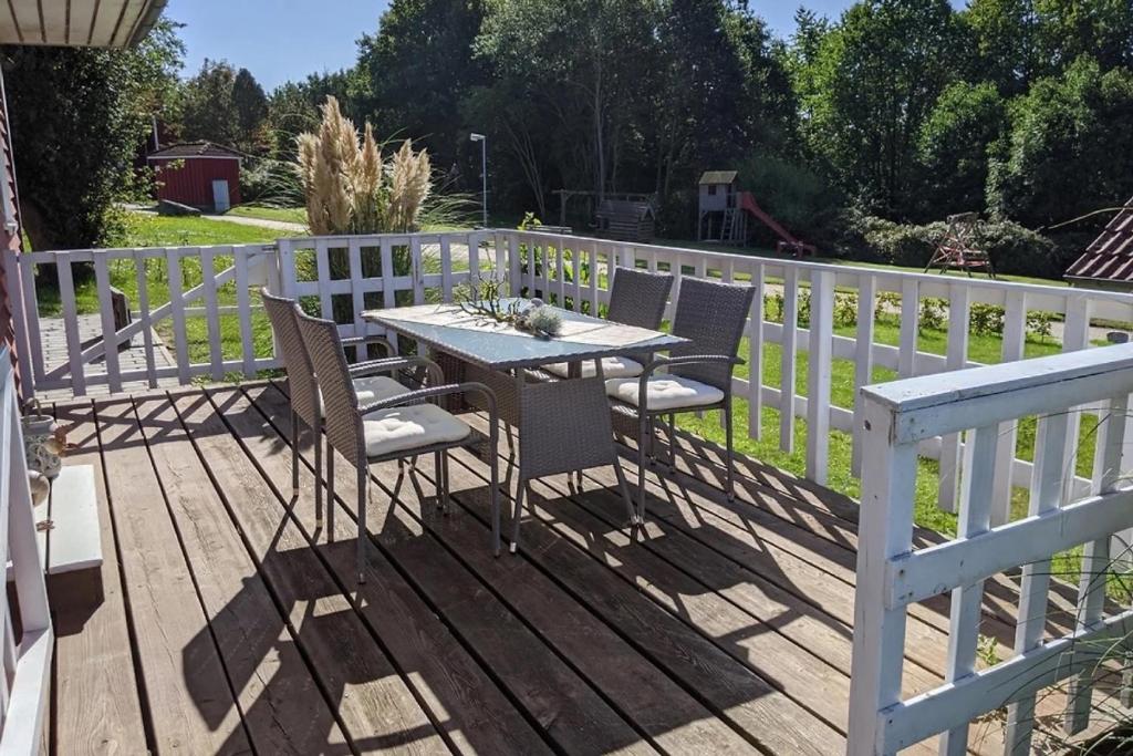 a table and chairs on a wooden deck at Seestern Ostsee in Mönchneversdorf