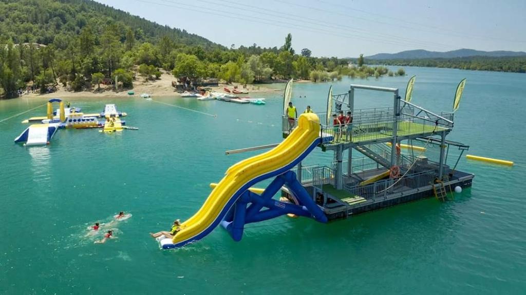 a water slide in the middle of a lake at LES ROCHES DE BAUDISSET in Saint-Paul-en-Forêt