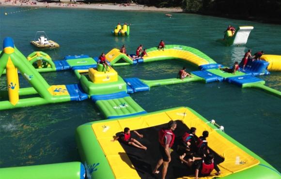 a group of people on inflatable slides in the water at LES ROCHES DE BAUDISSET in Saint-Paul-en-Forêt