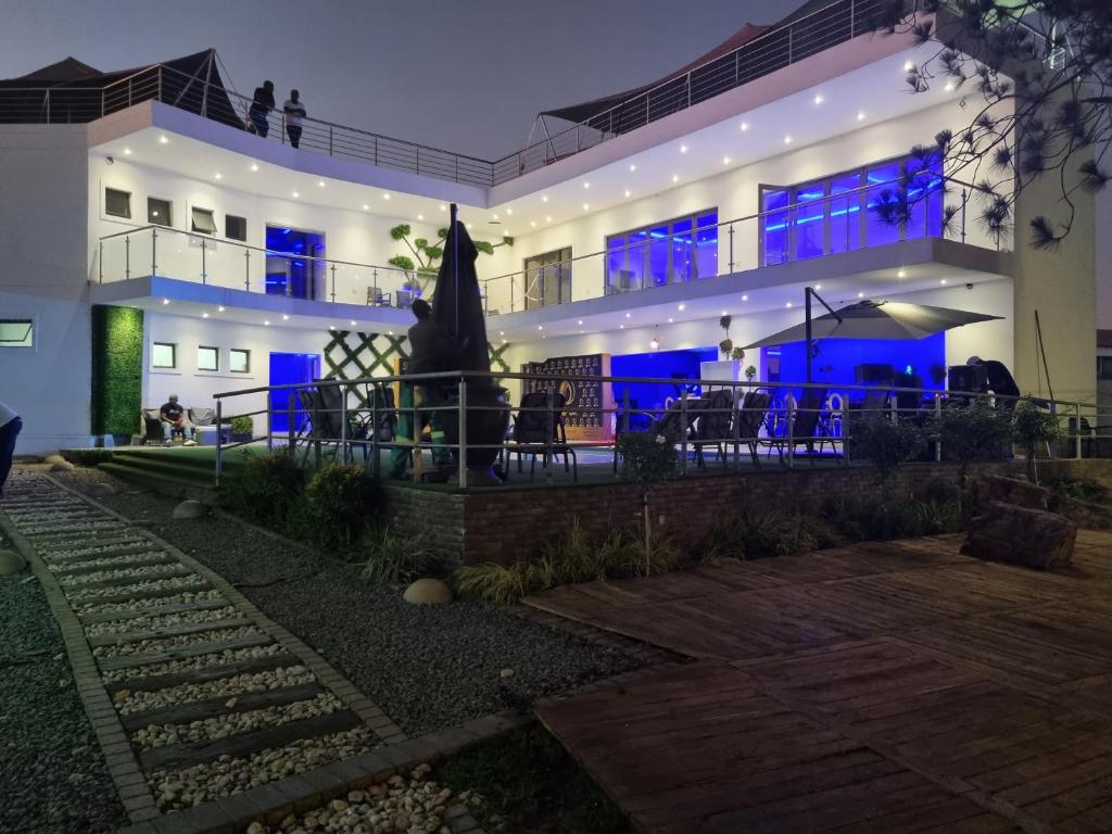 a building with a statue in front of it at night at Botle Ba Afrika Lodge in Vereeniging