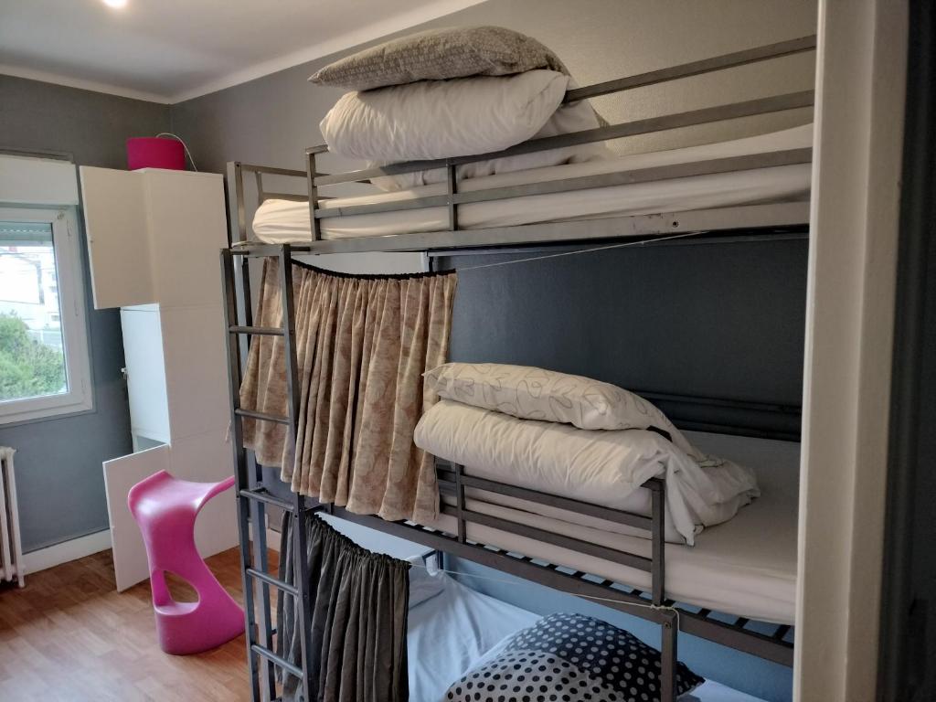 a couple of bunk beds in a room with pillows at lit en dortoir toulouse minimes in Toulouse