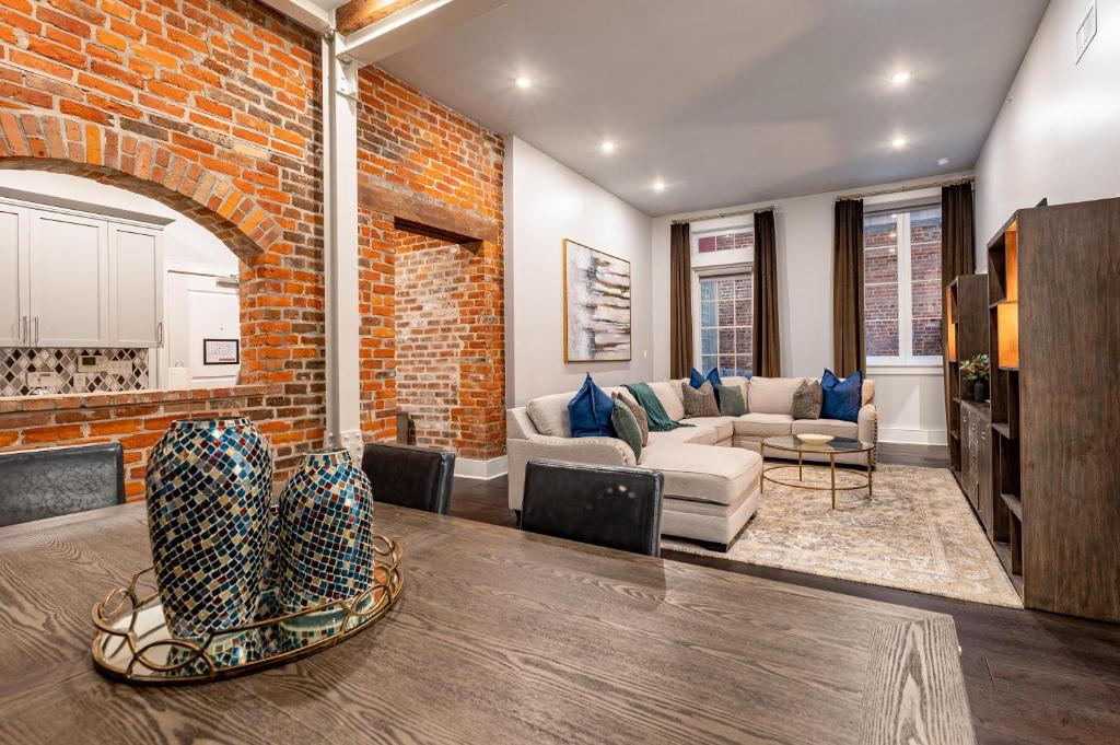 a living room with a brick wall and a table at The Crescent in New Orleans