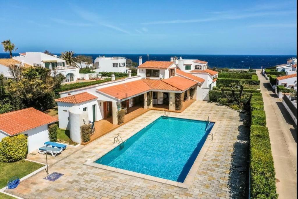 an aerial view of a house with a swimming pool at LA CALMA Espectacular villa con jardín y piscina en Menorca in S'Algar